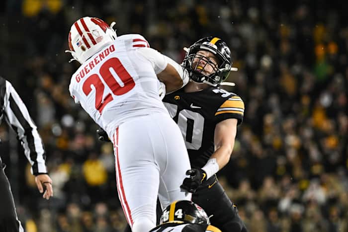 Nov 12, 2022; Iowa City, Iowa, USA; Iowa Hawkeyes defensive back Quinn Schulte (30) and Wisconsin Badgers running back Isaac Guerendo (20) in action during the game at Kinnick Stadium. Mandatory Credit: Jeffrey Becker-USA TODAY Sports